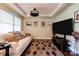 Relaxing living room area with plush white sofa, soft rug, and media center at 111 Gordon Ave, Shelby, NC 28152