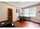 Simple office space with hardwood floors and a large window providing natural light at 111 Gordon Ave, Shelby, NC 28152