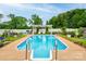 Backyard in-ground pool with ladder and patio is surrounded by green landscaping and a white fence at 111 Gordon Ave, Shelby, NC 28152