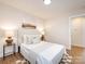 Neutral bedroom with modern decor such as stylish lamps and wall art, plus neutral bedding at 1152 Penrose Ln, Charlotte, NC 28217