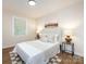 This bedroom showcases decor such as lamps, wall art, pillows, and neutral tones for a modern look at 1152 Penrose Ln, Charlotte, NC 28217