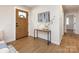 Bright foyer featuring wood flooring and a stylish console table, creating a welcoming entrance at 1152 Penrose Ln, Charlotte, NC 28217