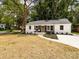Charming renovated home features an inviting entrance, fresh landscaping, and mature trees at 1152 Penrose Ln, Charlotte, NC 28217