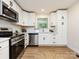 Bright kitchen featuring white cabinets, stainless steel appliances, and modern finishes at 1152 Penrose Ln, Charlotte, NC 28217