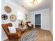 Relaxing living room with stylish décor, two chairs, and a view to a connecting room at 1152 Penrose Ln, Charlotte, NC 28217