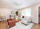 Cozy living space showcasing a plush sofa, round wood coffee table, and stylish ceiling fan at 1152 Penrose Ln, Charlotte, NC 28217