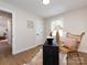 This bright office space offers a dark desk, wicker chair, and a doorway to the rest of the house at 1152 Penrose Ln, Charlotte, NC 28217