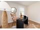 Well-lit office features stylish furniture, a dark desk, bright windows, and wood-look floors at 1152 Penrose Ln, Charlotte, NC 28217