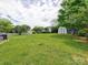 Large, grassy backyard featuring a storage shed at 121 Royalton Rd, Mooresville, NC 28115