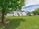 Spacious backyard featuring lush lawn, swing set, and mature trees at 121 Royalton Rd, Mooresville, NC 28115