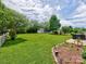 Lush backyard featuring a shed, well-maintained lawn, and patio area at 121 Royalton Rd, Mooresville, NC 28115
