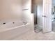 Bathroom boasting a soaking tub, shower, and neutral tile flooring at 121 Royalton Rd, Mooresville, NC 28115