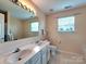 Bathroom featuring a double sink vanity, large mirror, and tile flooring at 121 Royalton Rd, Mooresville, NC 28115