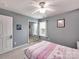 Light-filled bedroom with sliding closet doors and a plush, carpeted floor at 121 Royalton Rd, Mooresville, NC 28115
