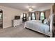 Large carpeted bedroom with neutral walls, desk, and a large bed at 121 Royalton Rd, Mooresville, NC 28115