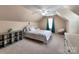 Bright bedroom featuring a sloped ceiling, neutral tones, carpet, and ample natural light at 121 Royalton Rd, Mooresville, NC 28115