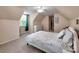 This carpeted bedroom offers neutral tones, ample lighting and a sloped ceiling at 121 Royalton Rd, Mooresville, NC 28115