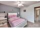 Bedroom with a white bed, pink accents, and natural light streaming in at 121 Royalton Rd, Mooresville, NC 28115