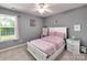 Charming bedroom with a white bed frame, pink bedding, and ample natural light at 121 Royalton Rd, Mooresville, NC 28115