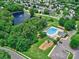 Aerial view of community amenities featuring a pool, playground, and serene pond enhancing the neighborhood appeal at 121 Royalton Rd, Mooresville, NC 28115
