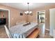 Spacious dining room featuring a dining table, a decorative light fixture, and beige walls at 121 Royalton Rd, Mooresville, NC 28115