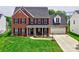 Beautiful two-story brick home with a well-manicured lawn and inviting front porch at 121 Royalton Rd, Mooresville, NC 28115