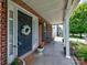 Inviting covered front porch with lovely wreath and outdoor seating at 121 Royalton Rd, Mooresville, NC 28115