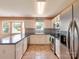 Well-lit kitchen features stainless steel appliances, white cabinetry, and a breakfast bar at 121 Royalton Rd, Mooresville, NC 28115