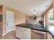 Bright kitchen featuring an island countertop, stainless steel dishwasher, and tile flooring at 121 Royalton Rd, Mooresville, NC 28115