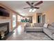 Open concept living room featuring a fireplace, gray sofa, and easy access to the kitchen at 121 Royalton Rd, Mooresville, NC 28115
