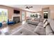 Open concept living room with a fireplace, gray sofa, and a view into the kitchen at 121 Royalton Rd, Mooresville, NC 28115