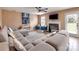 Cozy living room with a gray sectional sofa, fireplace, and a door to the backyard at 121 Royalton Rd, Mooresville, NC 28115