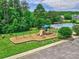 Community playground with swings and slides; surrounded by lush greenery and near a community pool at 121 Royalton Rd, Mooresville, NC 28115