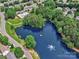 Aerial view showcasing a serene community pond with a fountain, surrounded by lush greenery and neighborhood homes at 121 Royalton Rd, Mooresville, NC 28115