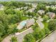 An aerial view of the community pool, landscaping, and surrounding neighborhood, showcasing a tranquil and inviting community at 12923 Plumleaf Dr, Charlotte, NC 28213