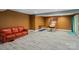 Finished basement with a red leather couch and entertainment space, including vinyl floors at 12923 Plumleaf Dr, Charlotte, NC 28213