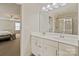 Bathroom featuring a double sink vanity and a glass-enclosed shower at 12923 Plumleaf Dr, Charlotte, NC 28213