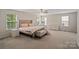 Large bedroom with two windows and a ceiling fan, offering plenty of space and light at 12923 Plumleaf Dr, Charlotte, NC 28213