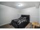 Bedroom with laminate flooring, a double bed, and bright white walls at 12923 Plumleaf Dr, Charlotte, NC 28213
