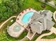 Overhead view showcasing a community pool with ample seating, surrounded by lush landscaping and mature trees at 12923 Plumleaf Dr, Charlotte, NC 28213