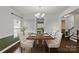 Formal dining room with hardwood floors, elegant chandelier, and stylish seating at 12923 Plumleaf Dr, Charlotte, NC 28213