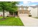 Charming two-story brick home with a covered front porch and attached two-car garage at 12923 Plumleaf Dr, Charlotte, NC 28213