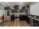 Well-equipped kitchen with stainless steel appliances, granite countertops, and dark cabinetry at 12923 Plumleaf Dr, Charlotte, NC 28213