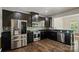 Well-equipped kitchen with stainless steel appliances, granite countertops, and dark cabinetry at 12923 Plumleaf Dr, Charlotte, NC 28213