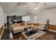 Open-concept living area with hardwood floors, modern furnishings, and seamless kitchen access at 12923 Plumleaf Dr, Charlotte, NC 28213