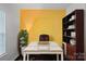 Bright office space with hardwood floors, modern desk, and built-in shelving for storage at 12923 Plumleaf Dr, Charlotte, NC 28213