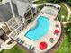 Aerial view of the community pool with red umbrellas and ample seating, providing a perfect spot for summer relaxation at 12923 Plumleaf Dr, Charlotte, NC 28213