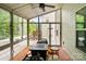 Enclosed sunroom features a ceiling fan, and sliding glass doors, offering a versatile space for relaxation and entertaining at 12923 Plumleaf Dr, Charlotte, NC 28213