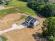 Newly built home showcasing a long driveway, spacious land, close to the street, with surrounding greenery at 1308 Austin Chaney Rd, Wingate, NC 28174