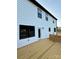 Exterior of a home with white siding and a wooden back deck and black trimmed windows at 1308 Austin Chaney Rd, Wingate, NC 28174